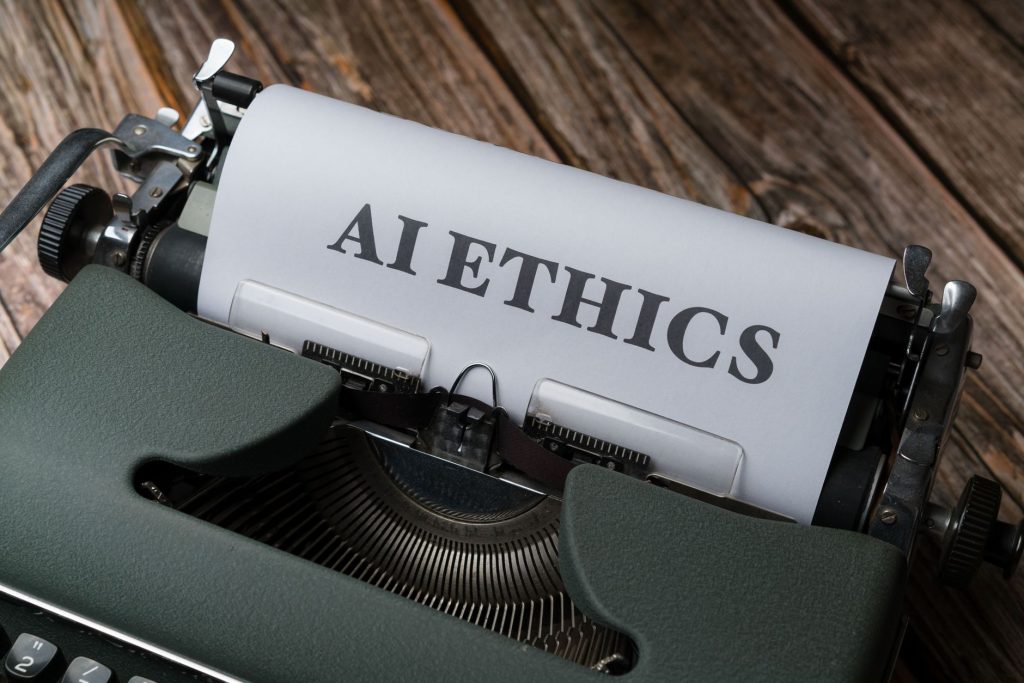 Inaep cria guia para orientar uso ético da inteligência artificial em pesquisas com seres humanos Máquina de escrever antiga com a expressão “AI Ethics” datilografada em uma folha de papel.